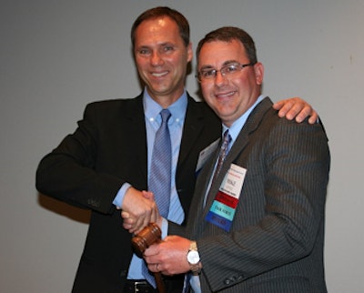 Outgoing USAPEEC Chairman Charles von der Heyde of Pilgrim’s Mexico, left, passes the ceremonial Hoben Gavel to Mike Little of Mountaire Farms, who assumes the chairmanship for 2014-15. The gavel is named for two-time USAPEEC Chairman Jim Hoben, who crafted the piece in his wood shop.