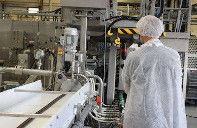 A workshop participant examines a Clextral extruder during the Animal Feed Extrusion Course on October 16, 2018 in Saint-Etienne, France. | photo courtesy Clextral