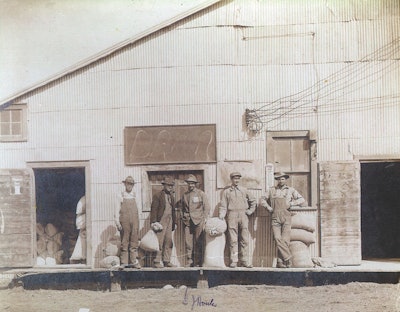 The Houle family poses in front of their feed mill’s shipping dock. Gary Houle, the mill’s final owner, decided to close the company this year due to the difficulty of finding a successor. Otherwise, he says, the business was doing well, serving a growing market driven by local hobby farms. (Courtesy Houle’s Feed Mill)