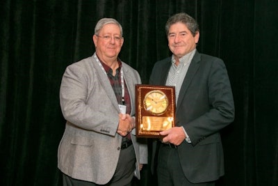 Randy Fry of Ceres Solutions (left) awards Joe Tevis of VIS Consulting with AgGateway's top leadership award. Photo by AgGateway