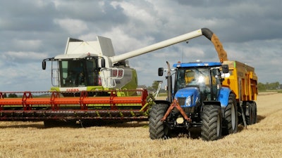 Blue tractor next to white farm vehicle at daytime 163752