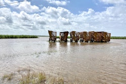 Wagons used for harvesting sugarcane sit on high ground surrounded by floodwaters from Hurricane Laura near New Iberia, Louisiana. Photo by Bruce Schultz/LSU AgCenter