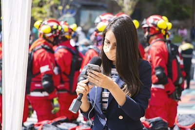 Jounalist with fire crews behind her via pixabay mar 2022