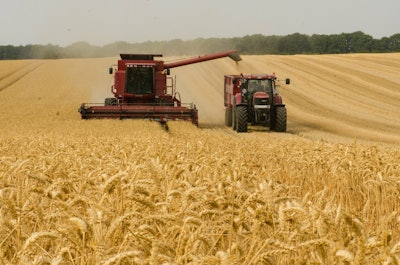 Red tractor and combine in wheat field via pixabay Mar 2022