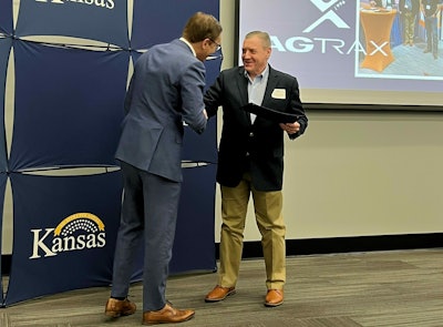 David Toland, Kansas Lieutenant Governor & Secretary of Commerce, presents the Award to Michael Hinton, AgTrax director of Sales & Marketing. Photo: AgTrax