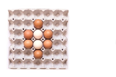 Eggs in paper tray isolated on white background