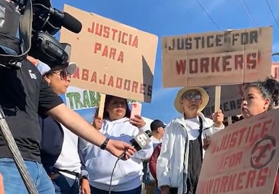 Protesters in Van Buren, Arkansas, talk to a television reporter about their grievances with Tyson Foods, which is closing a poultry plant in the community. (Venceremos | Facebook)