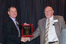 Outgoing chairman Brent Emch (left) of Cargill Inc., is presented a recognition plaque by incoming chairman Mark Paul of Cloud County Cooperative. Courtesy of Kansas Grain and Feed Association.