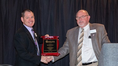 Outgoing chairman Brent Emch (left) of Cargill Inc., is presented a recognition plaque by incoming chairman Mark Paul of Cloud County Cooperative. Courtesy of Kansas Grain and Feed Association.
