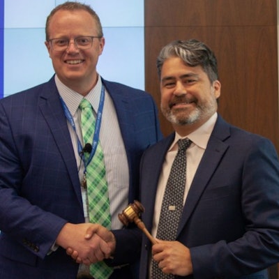 Mike Gauss hands over the reins to Carlos Gonzalez during AFIA's annual board of directors meeting.