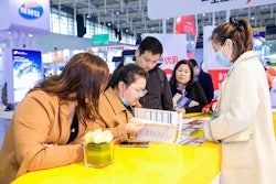 The U.S. Grains Council's (USGC's) staff in China recently welcomed China Feed Industry Expo visitors to the Council's booth to learn more about the Council's work, while getting to better know the needs of Chinese customers. Pictured, Linda Li (right), USGC ethanol programs coordinator in China, talked with expo attendees.