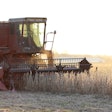 Farmer Harvesting Soybeans In Field