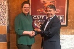 Megan Fulmer receives her award from AFIA's Carlo Gonzalez.
