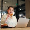 Business Woman Eating Chicken