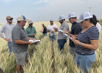 The U.S. Grains Council (USGC) recently organized farm visits, educational opportunities and business-to-business meetings between a major Mexican brewing company and stakeholders in the U.S. barley industry. Pictured, Montana Wheat and Barley Board Member Kevin Bradley (second from left) speaks to attendees about his crop and shares an informational brochure about barley production and applications he created with his children.