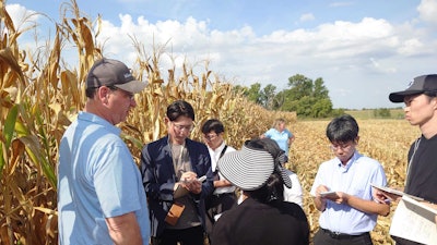 Last week, the U.S. Grains Council (USGC) sponsored a team of new Japanese feed grain purchasers that toured the U.S. corn value chain to build their understanding and trust in how U.S. corn is grown and shipped. Pictured, group participants speak to Missouri Corn Merchandising Council Board Member Brian Willott (leftmost) on his farm to learn about his operation and the upcoming harvest.