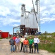 Representatives from Gerber & Sons, Inc., The Commercial & Savings Bank, and USDA Rural Development stand near the new feed mill site under construction in Baltic, Ohio.