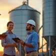 Workers Talking At Grain Elevator