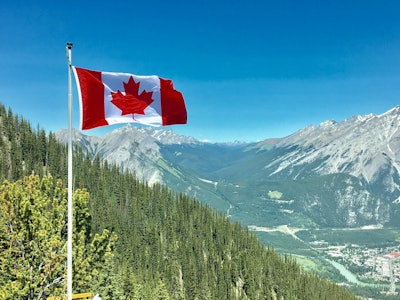 Canadian Flag In Mountains