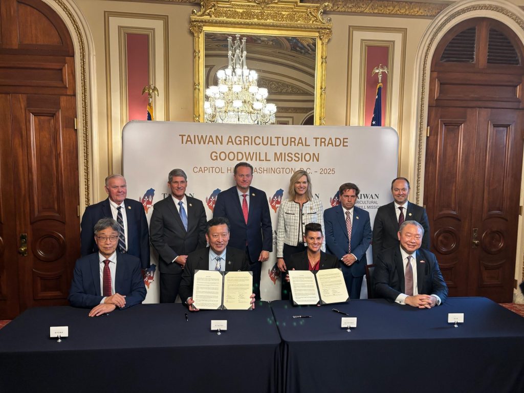 Taiwan Agricultural Trade Goodwill Mission delegates signing official documents in ceremonial room