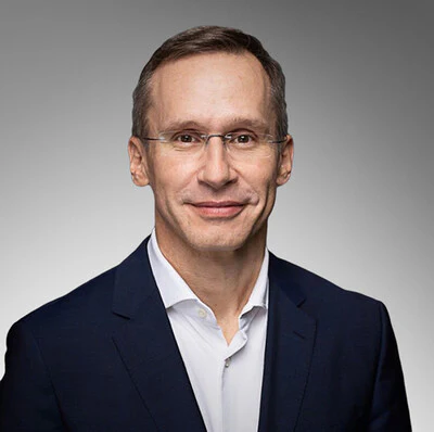 Professional man in navy blazer and white shirt, wearing glasses