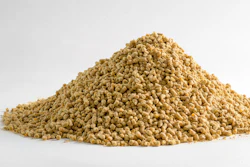 Pile of golden-tan granular pellets on white background