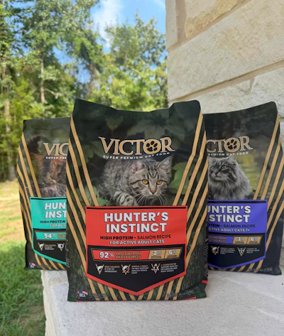 Three Victor Super Premium cat food bags featuring Hunter's Instinct formula with salmon recipe displayed outdoors