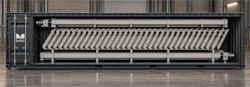 Industrial laundry pressing machine with parallel heated platens in warehouse setting