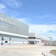 Nestlé Purina manufacturing facility with red checkered logo on white building facade and flags in foreground