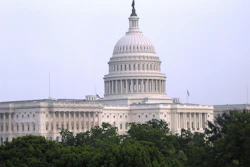 U.S. Capitol Building with iconic dome and neoclassical architecture surrounded by green trees
