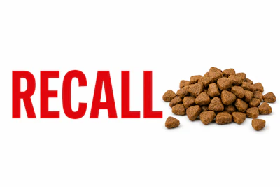 Pet food recall notice with brown kibble pile and red warning text