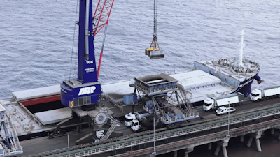 ABP industrial crane and port equipment loading cargo vessel at dock