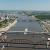 Aerial view of Detroit skyline with multiple bridges crossing the Detroit River, showing urban development and waterfront infrastructure.