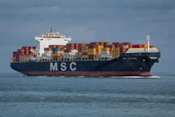 MSC container ship loaded with colorful cargo containers sailing on calm blue ocean waters