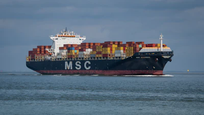 MSC container ship loaded with colorful cargo containers sailing on calm blue ocean waters