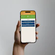 Hand holding smartphone displaying green and blue app interface with navigation menu