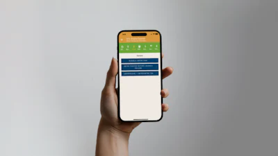 Hand holding smartphone displaying green and blue app interface with navigation menu