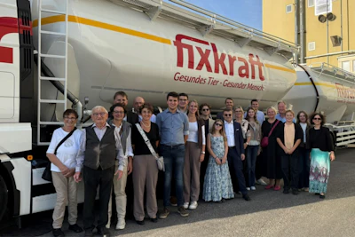 Group of people posing in front of a Nxkraft tanker truck at an industrial facility