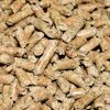 Close-up of tan and brown wood pellets or biomass fuel material with natural texture