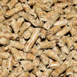 Close-up of tan and brown wood pellets or biomass fuel material with natural texture