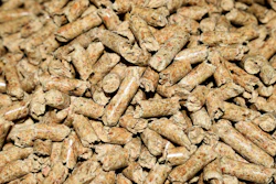 Close-up of tan and brown wood pellets or biomass fuel material with natural texture