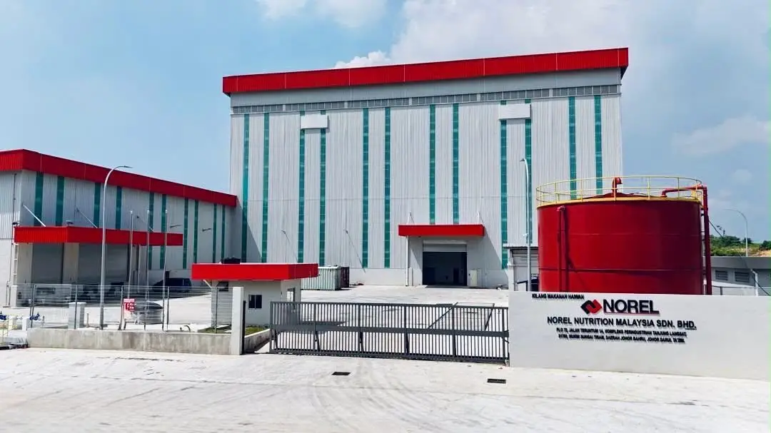 Norel Nutrition Malaysia manufacturing facility with red-roofed industrial building and white corrugated walls