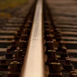 Railroad tracks with wooden sleepers converging toward the horizon in perspective view