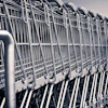 Row of stacked metal shopping carts lined up in a parking lot or storage area