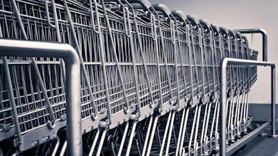 Row of stacked metal shopping carts lined up in a parking lot or storage area