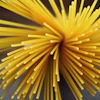 Yellow radial starburst with cylindrical strands radiating from center against dark background