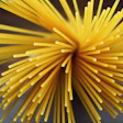 Yellow radial starburst with cylindrical strands radiating from center against dark background