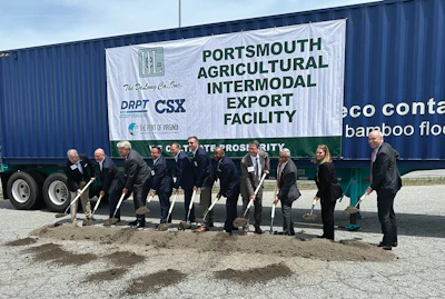Officials participate in groundbreaking ceremony for Portsmouth Agricultural Intermodal Export Facility with shipping container backdrop